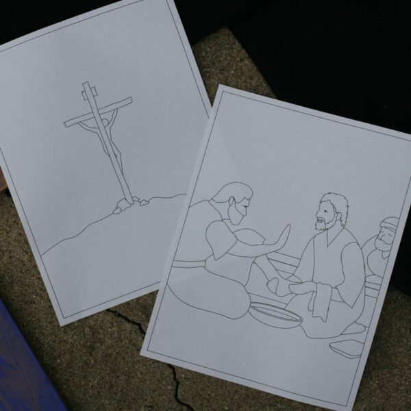 Photo of two pages from the Lent Coloring Book. One image is of Jesus washing Peter's feet, and the other is of Jesus on the cross.
